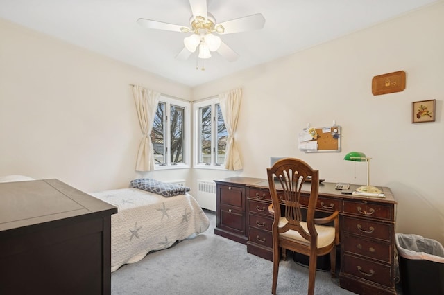 carpeted bedroom with ceiling fan and radiator heating unit