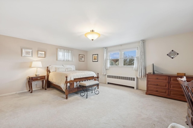 bedroom featuring light carpet and radiator heating unit