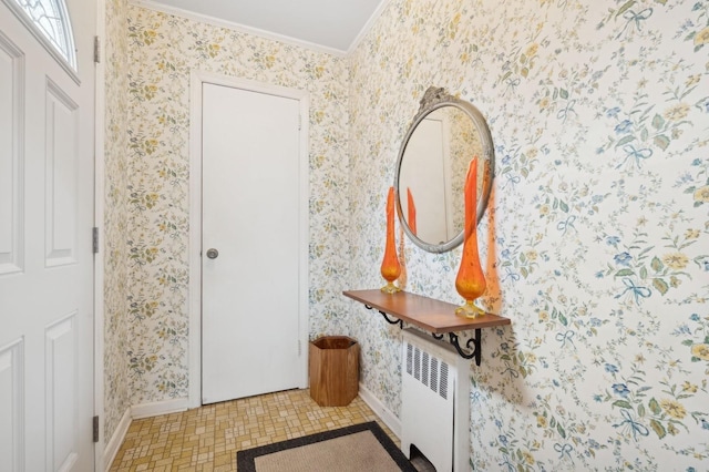 entryway with radiator and crown molding