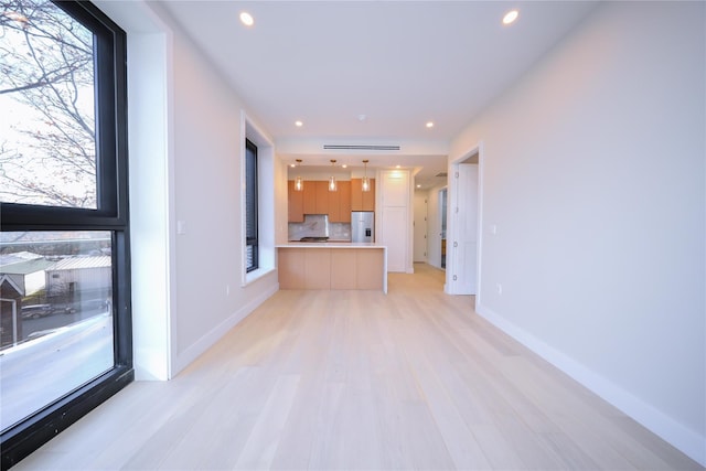 unfurnished living room with light hardwood / wood-style floors