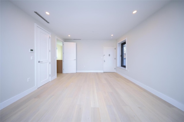 spare room with light hardwood / wood-style floors