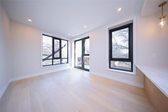 unfurnished room featuring light hardwood / wood-style flooring and french doors