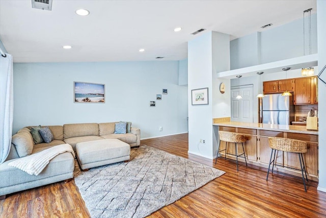 living room with hardwood / wood-style floors and lofted ceiling