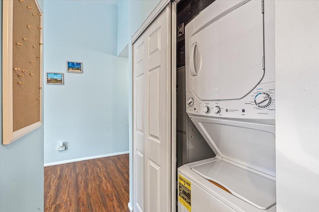 laundry room with stacked washer / dryer and dark hardwood / wood-style floors