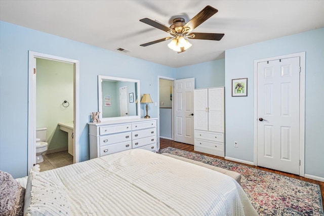 bedroom featuring ceiling fan and ensuite bath