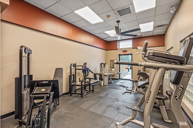 gym featuring a paneled ceiling and ceiling fan