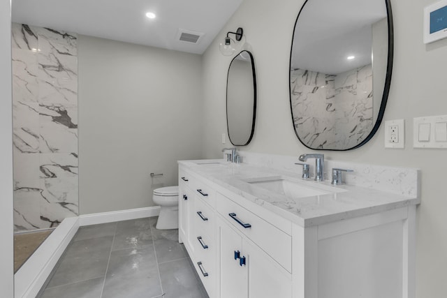 bathroom with vanity, toilet, and a shower