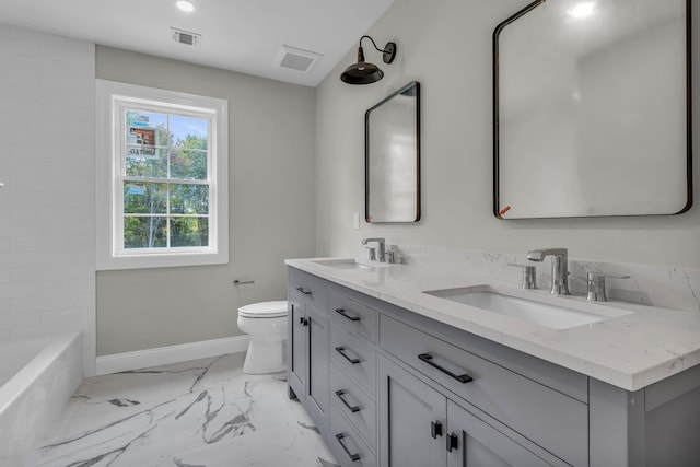 bathroom featuring vanity and toilet