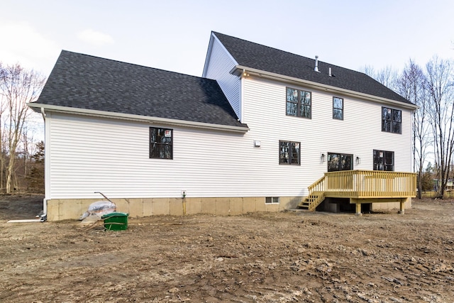 rear view of house featuring a wooden deck