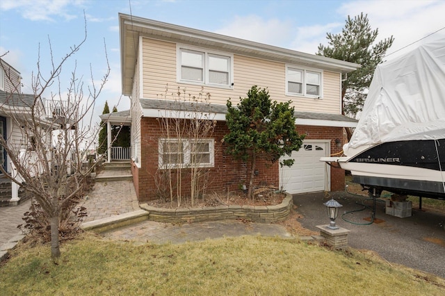 back of house featuring a lawn and a garage