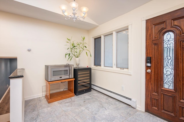 foyer entrance with a baseboard heating unit, a chandelier, and vaulted ceiling