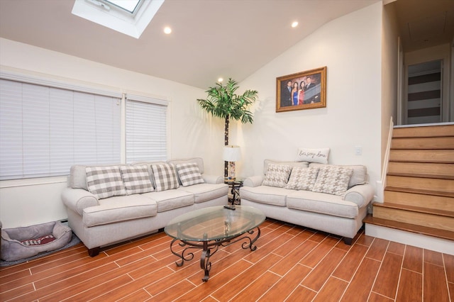 living room featuring lofted ceiling with skylight