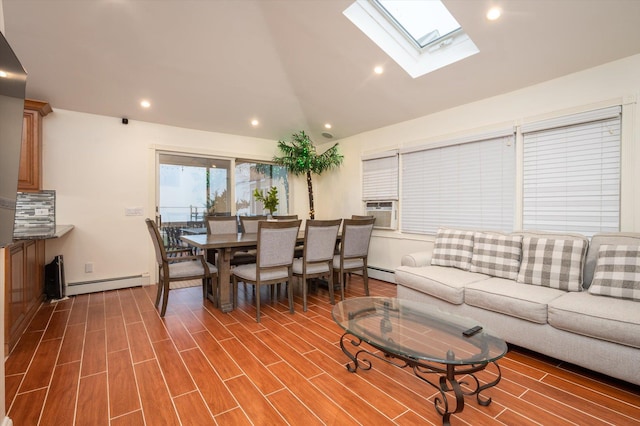 living room with baseboard heating, vaulted ceiling with skylight, and hardwood / wood-style flooring