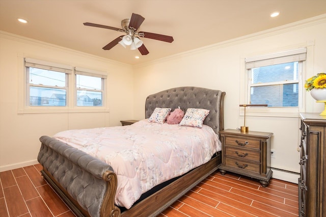 bedroom featuring baseboard heating, ceiling fan, and crown molding