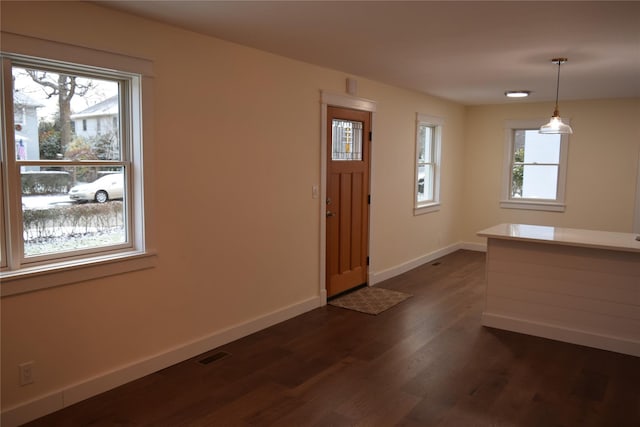 entryway featuring dark wood-type flooring, visible vents, and baseboards