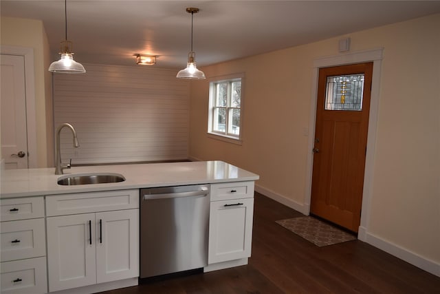 kitchen with baseboards, white cabinets, dark wood-type flooring, stainless steel dishwasher, and a sink