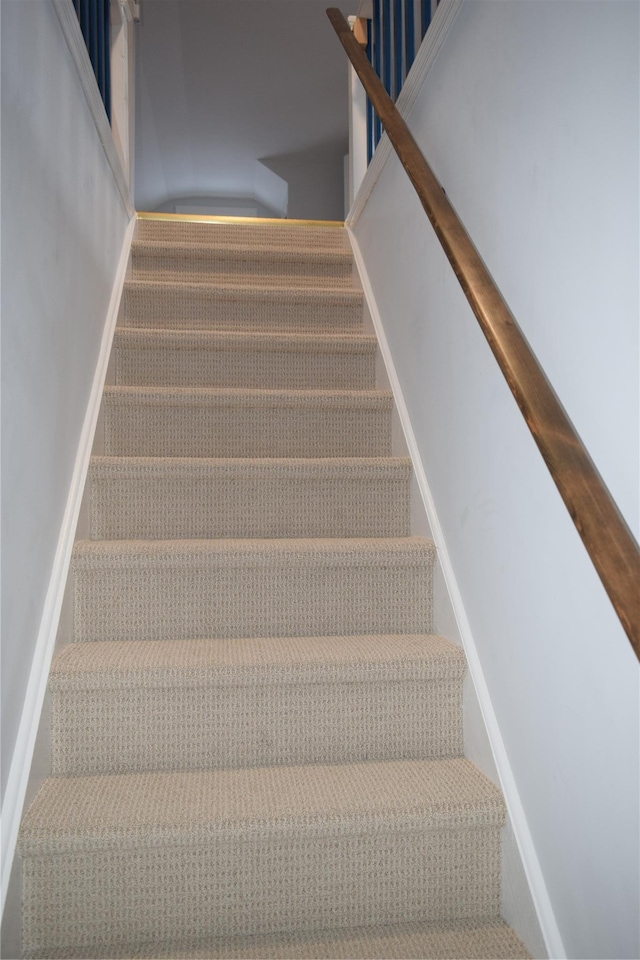 staircase featuring baseboards