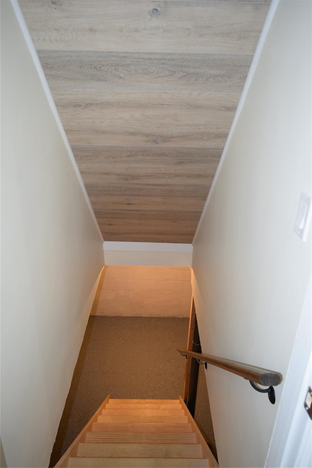 staircase featuring lofted ceiling