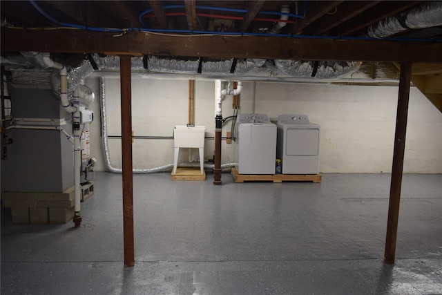 unfinished basement featuring a sink and separate washer and dryer