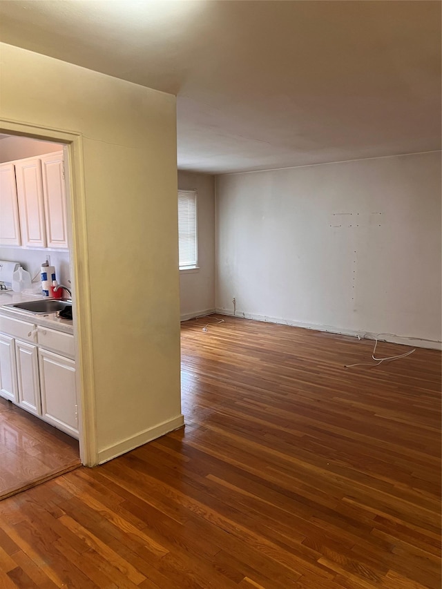 empty room featuring dark hardwood / wood-style flooring and sink