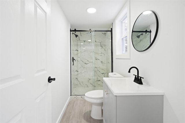 bathroom with vanity, an enclosed shower, hardwood / wood-style flooring, and toilet