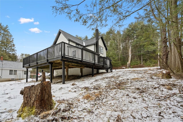 view of snow covered exterior featuring a deck