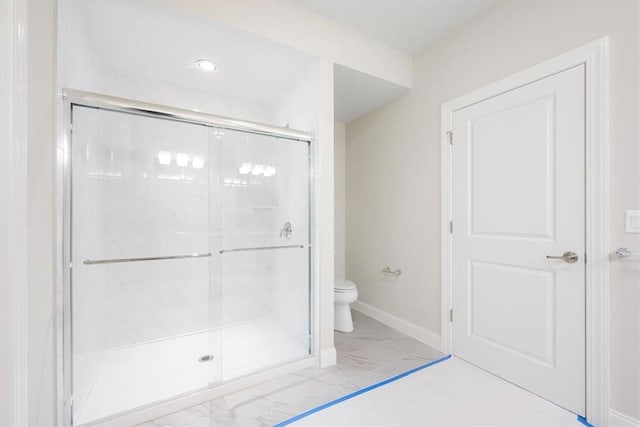 bathroom with toilet and walk in shower