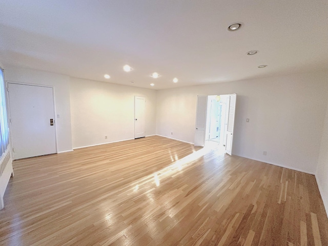 unfurnished room with light hardwood / wood-style flooring