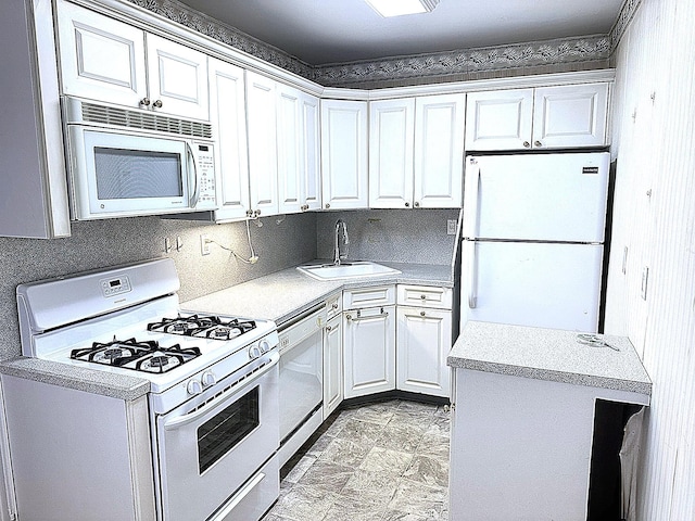 kitchen with white cabinetry, sink, and white appliances