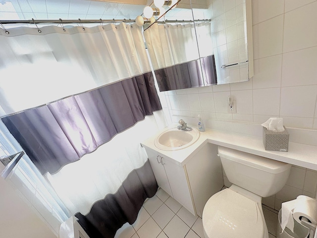 bathroom featuring tile patterned flooring, decorative backsplash, vanity, and tile walls