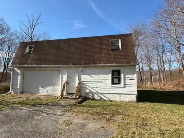 back of house with a garage