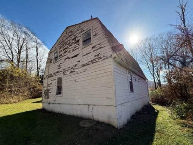 view of home's exterior with a yard