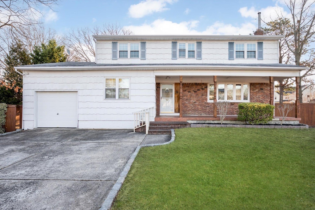 view of front facade featuring a front lawn and a garage