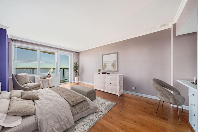 bedroom with access to outside, hardwood / wood-style flooring, and ornamental molding