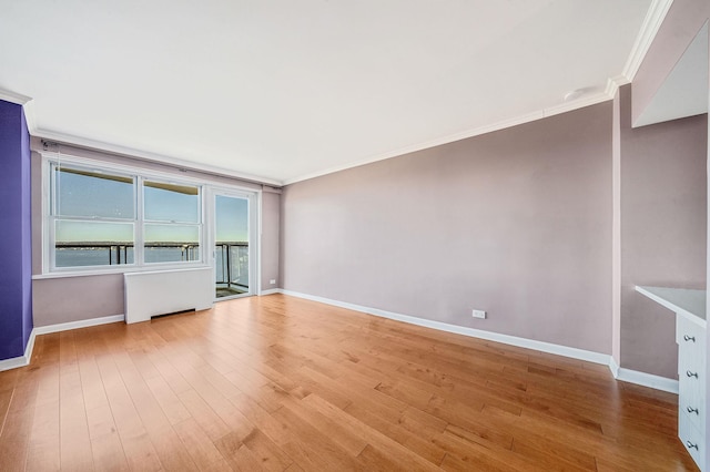 unfurnished living room with crown molding, radiator, and light hardwood / wood-style flooring