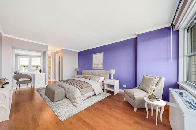 bedroom with hardwood / wood-style floors and crown molding