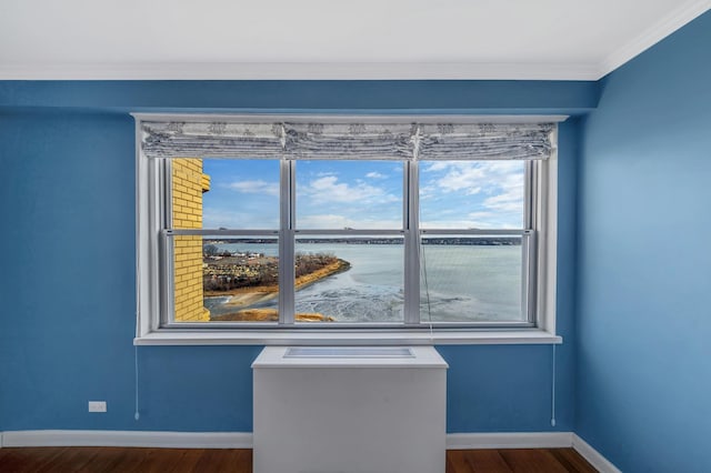 interior space featuring a water view, wood-type flooring, and crown molding