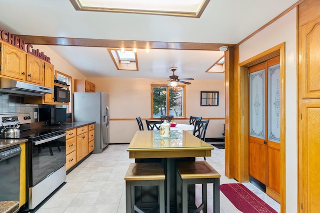 kitchen with black appliances, ceiling fan, lofted ceiling, and tasteful backsplash