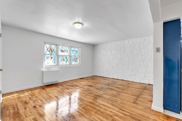 empty room with hardwood / wood-style flooring