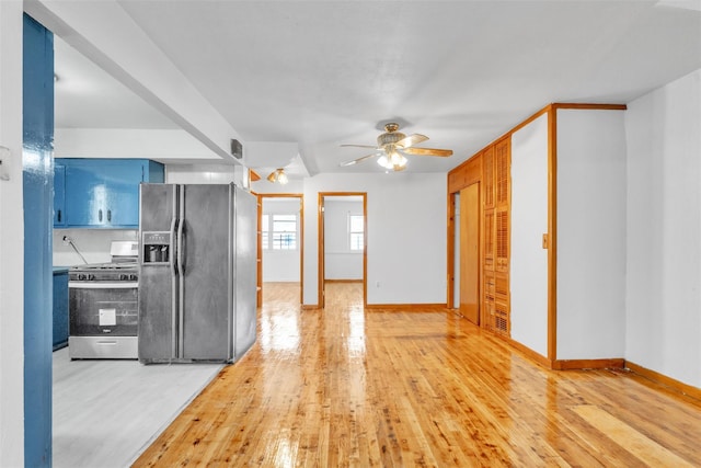 kitchen featuring blue cabinetry, hardwood / wood-style flooring, ceiling fan, and appliances with stainless steel finishes