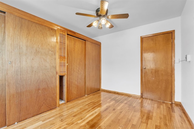 unfurnished bedroom with light wood-type flooring, a closet, and ceiling fan