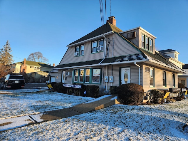 view of front of property with cooling unit and a garage