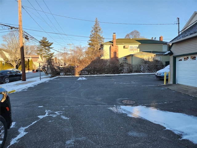 view of car parking featuring a garage