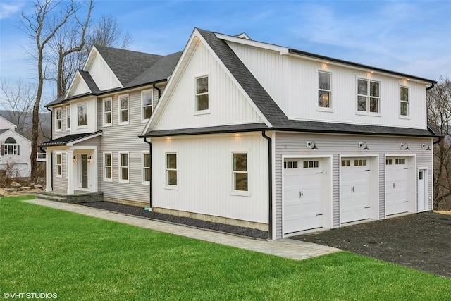 view of front of house with a front yard and a garage