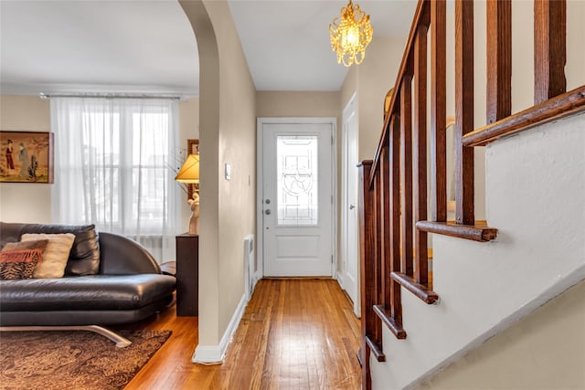 foyer with hardwood / wood-style floors, a notable chandelier, and a healthy amount of sunlight