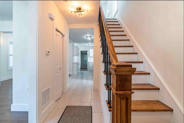 staircase featuring tile patterned floors