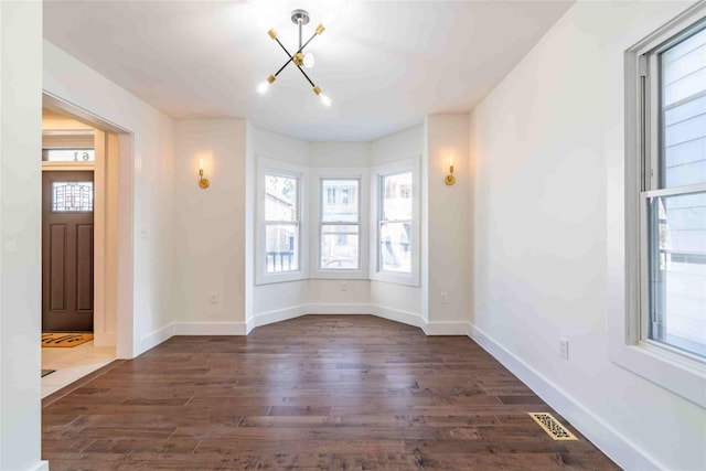 entryway with a chandelier and dark hardwood / wood-style floors