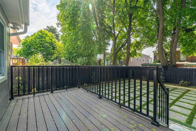 wooden deck featuring a lawn