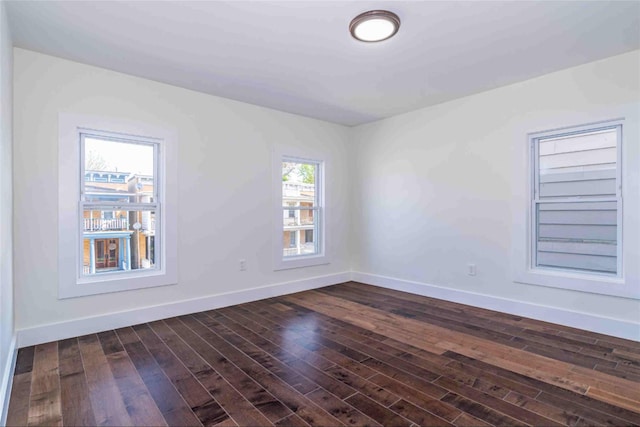 unfurnished room with dark hardwood / wood-style floors