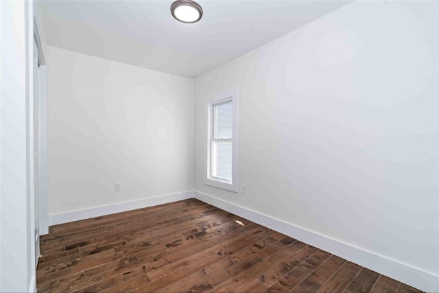 spare room with dark hardwood / wood-style floors